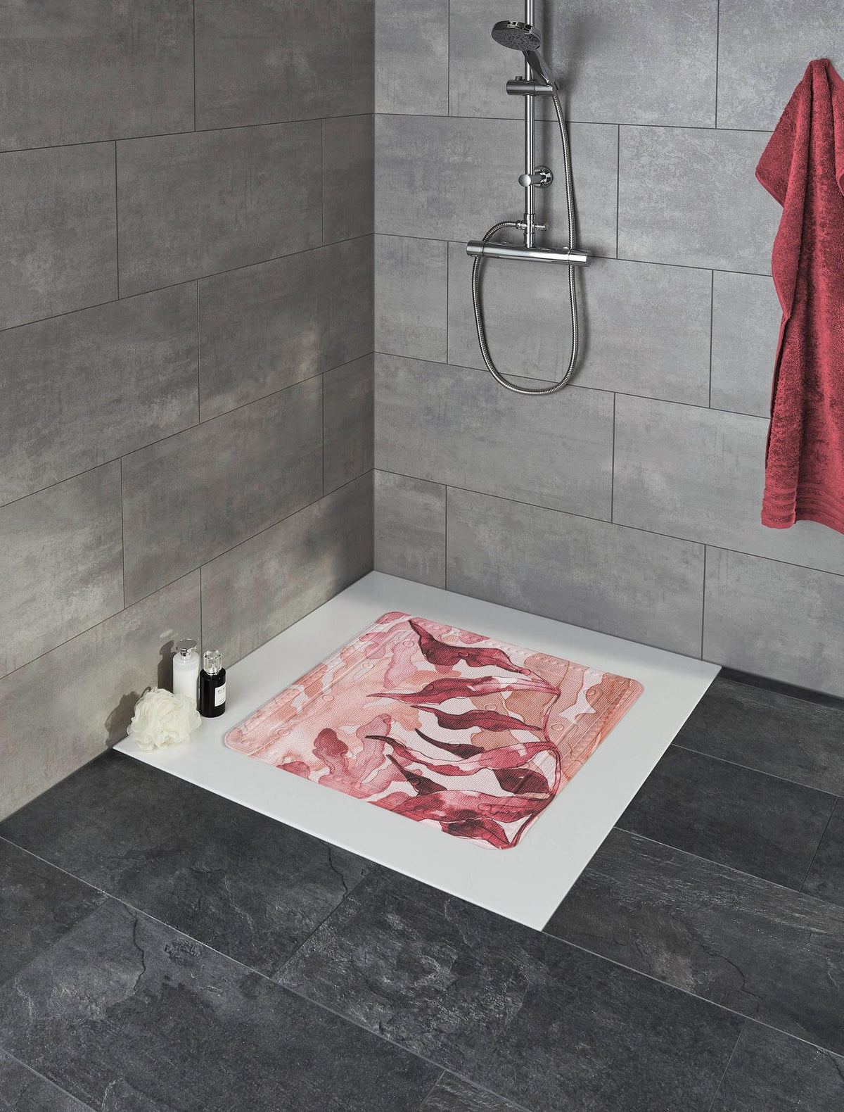 Walk-in-Dusche mit grauen Fliesen und rosa Duschmatte mit abstraktem Muster