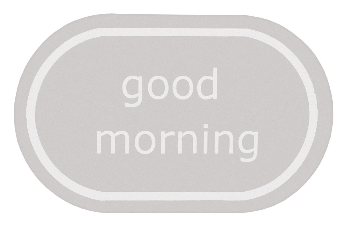 Ovaler hellgrauer Badteppich mit weißem Schriftzug good morning