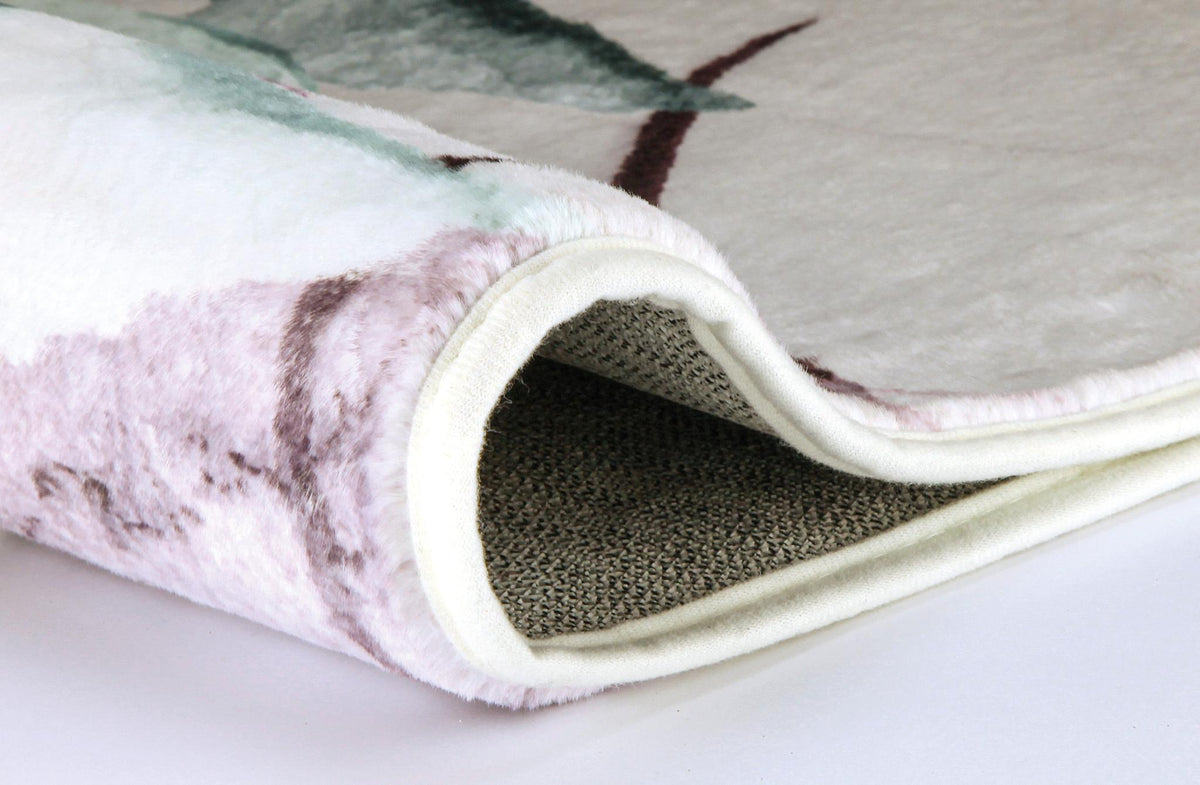 Gerollter, weicher Teppich mit floralem Muster in Creme, Rosa und Grün.