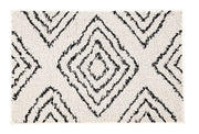 Weißer Badteppich mit schwarzen, grafischen Rautenmustern im Boho-Stil