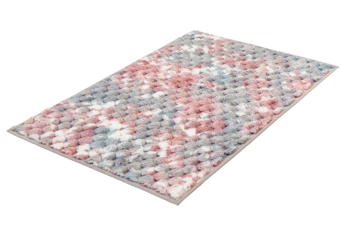 Flauschiger Teppich in Rosa, Grau und Weiß mit strukturierter Oberfläche.