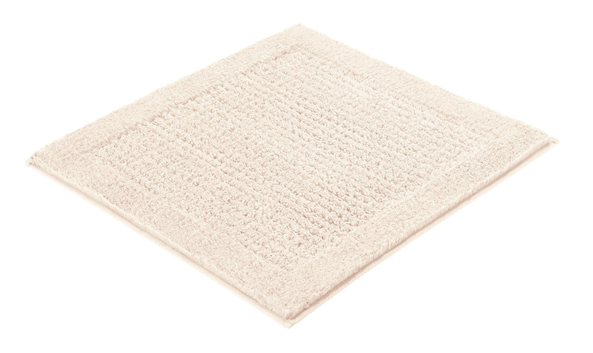 Quadratische cremefarbene Badematte mit breitem Struktur-Rand weich