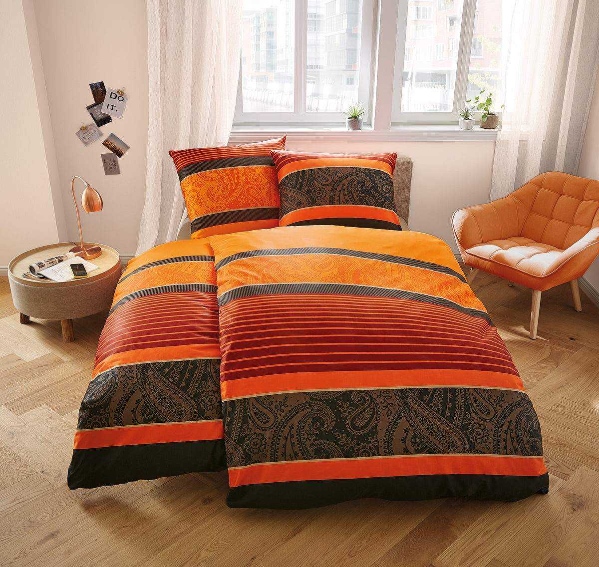 Orange-rote Bettwäsche mit Streifen und Paisley-Muster im Schlafzimmer