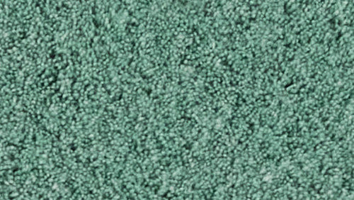 Nahaufnahme einer grünen, weichen Badematte mit weichem, dichtem Flor