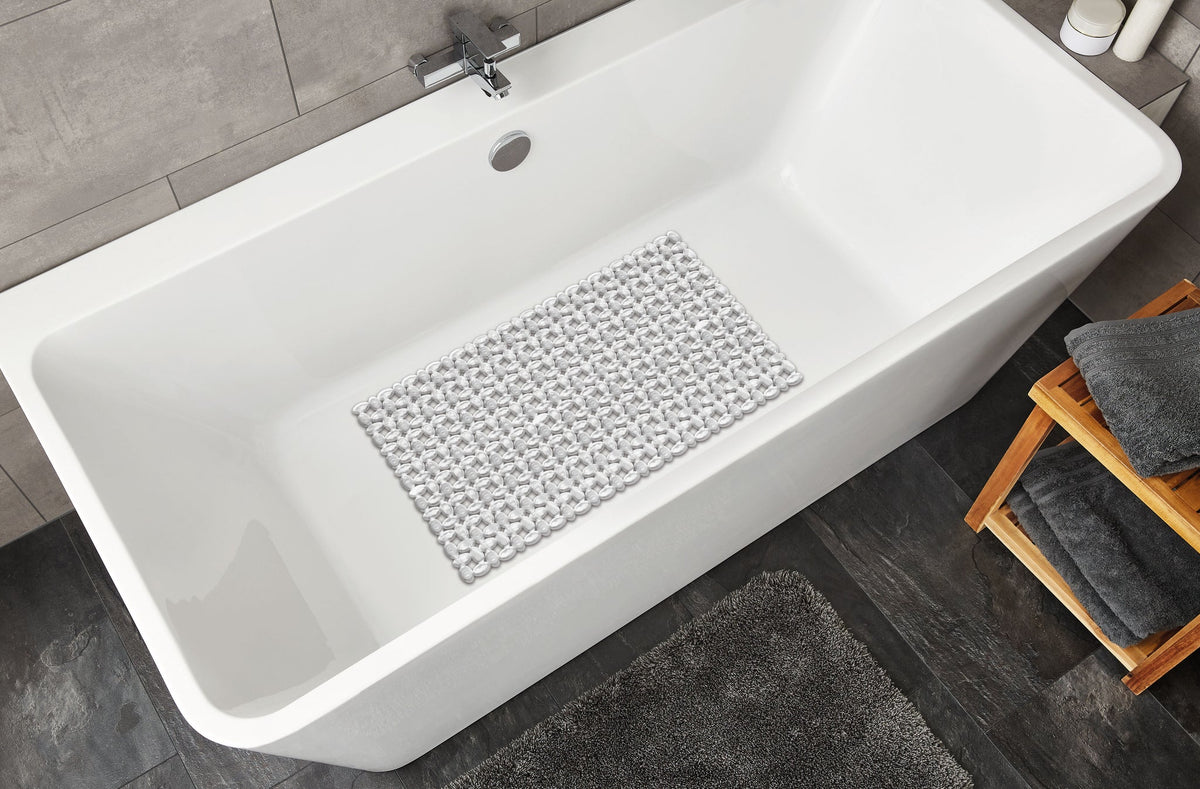 Weiße Badewanne mit transparenter rutschfester Badematte im Bodenbereich