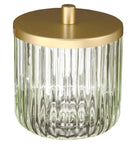 Geriffeltes Glasgefäß mit goldfarbenem Deckel vor weißem Hintergrund.